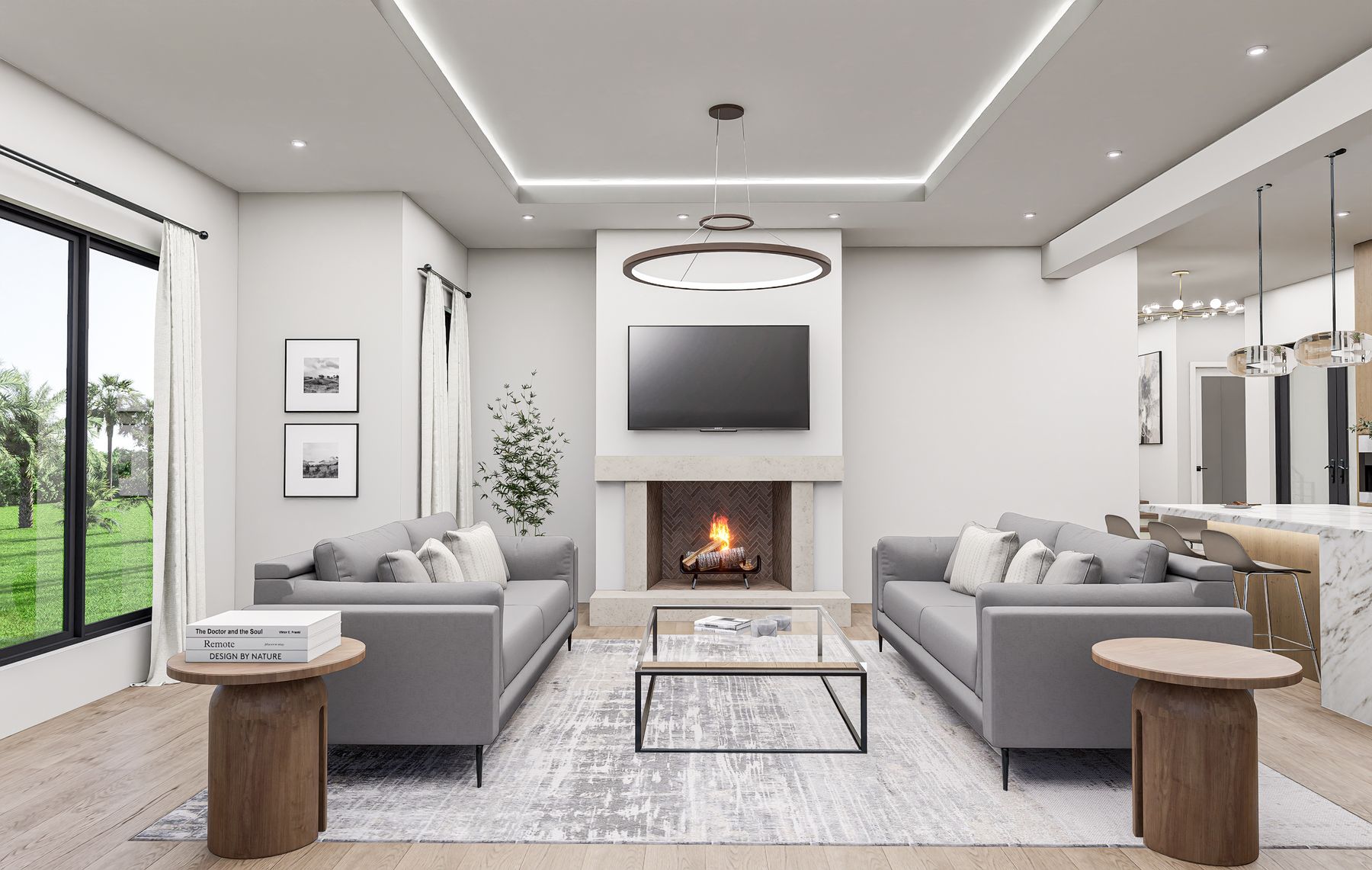 Open-concept great room with custom fireplace, tray ceiling, and chandelier